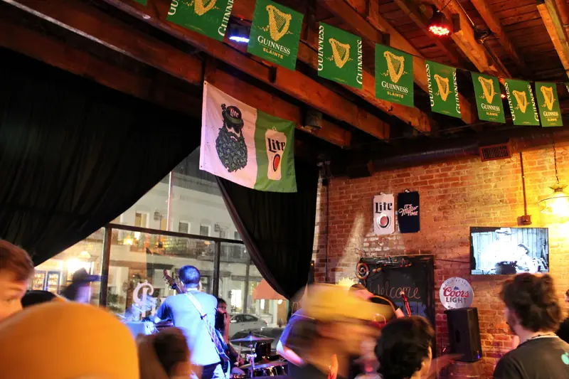 A band playing the front-window stage to a full room