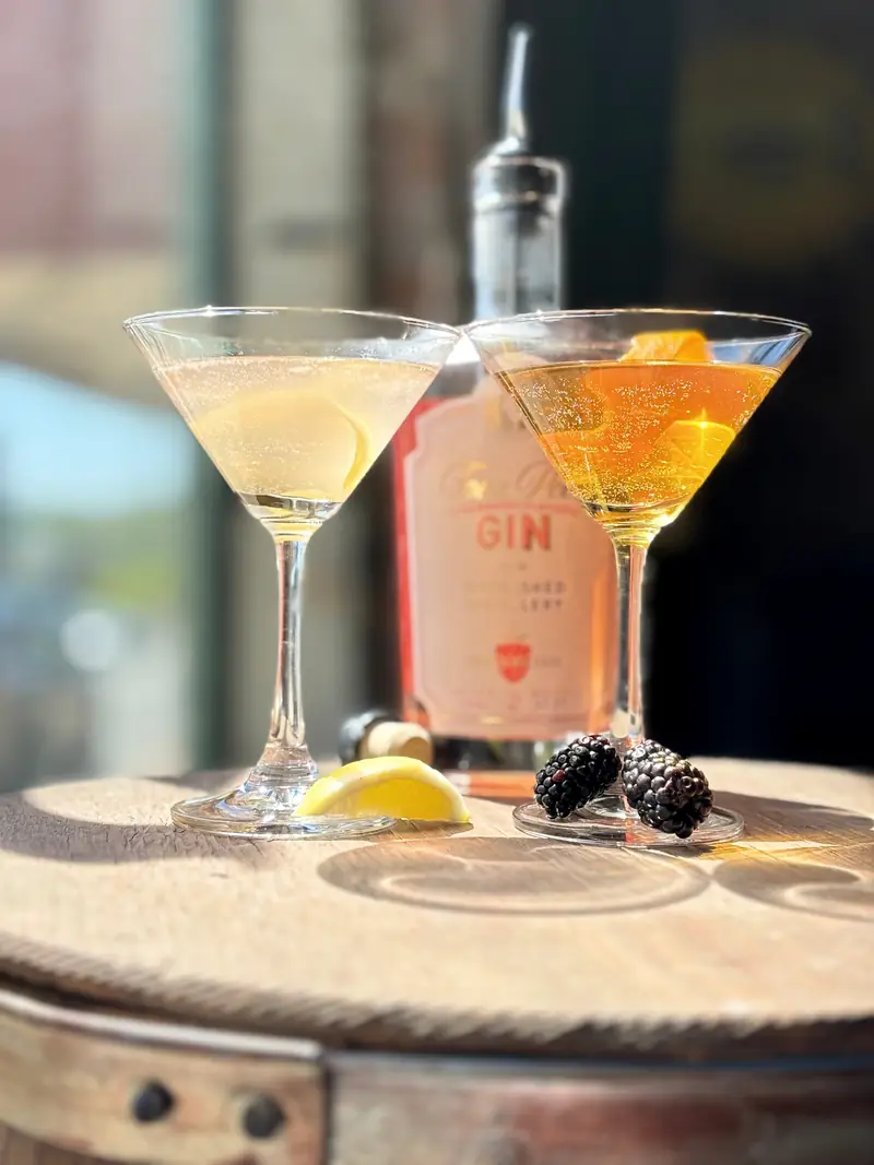 Two gin martinis on a barrel table