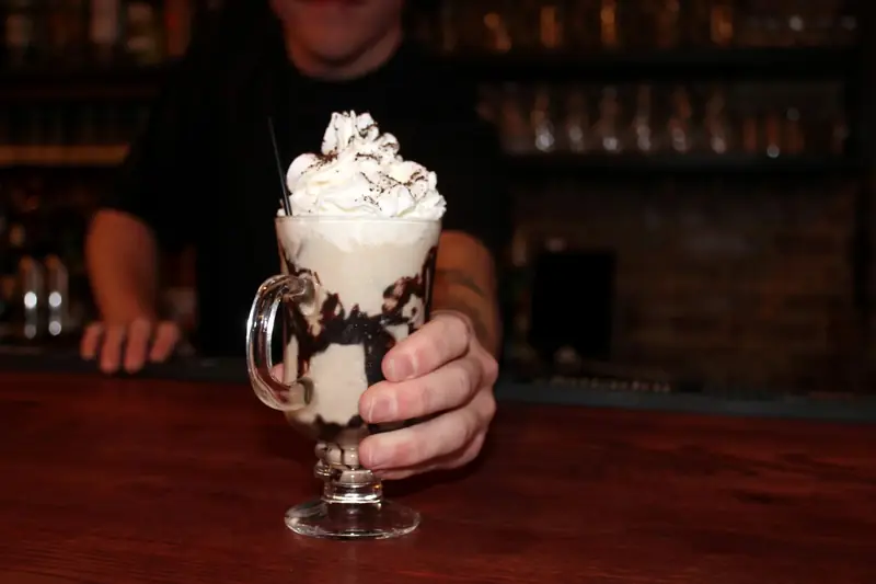 A whipped-cream cocktail handed across the bar